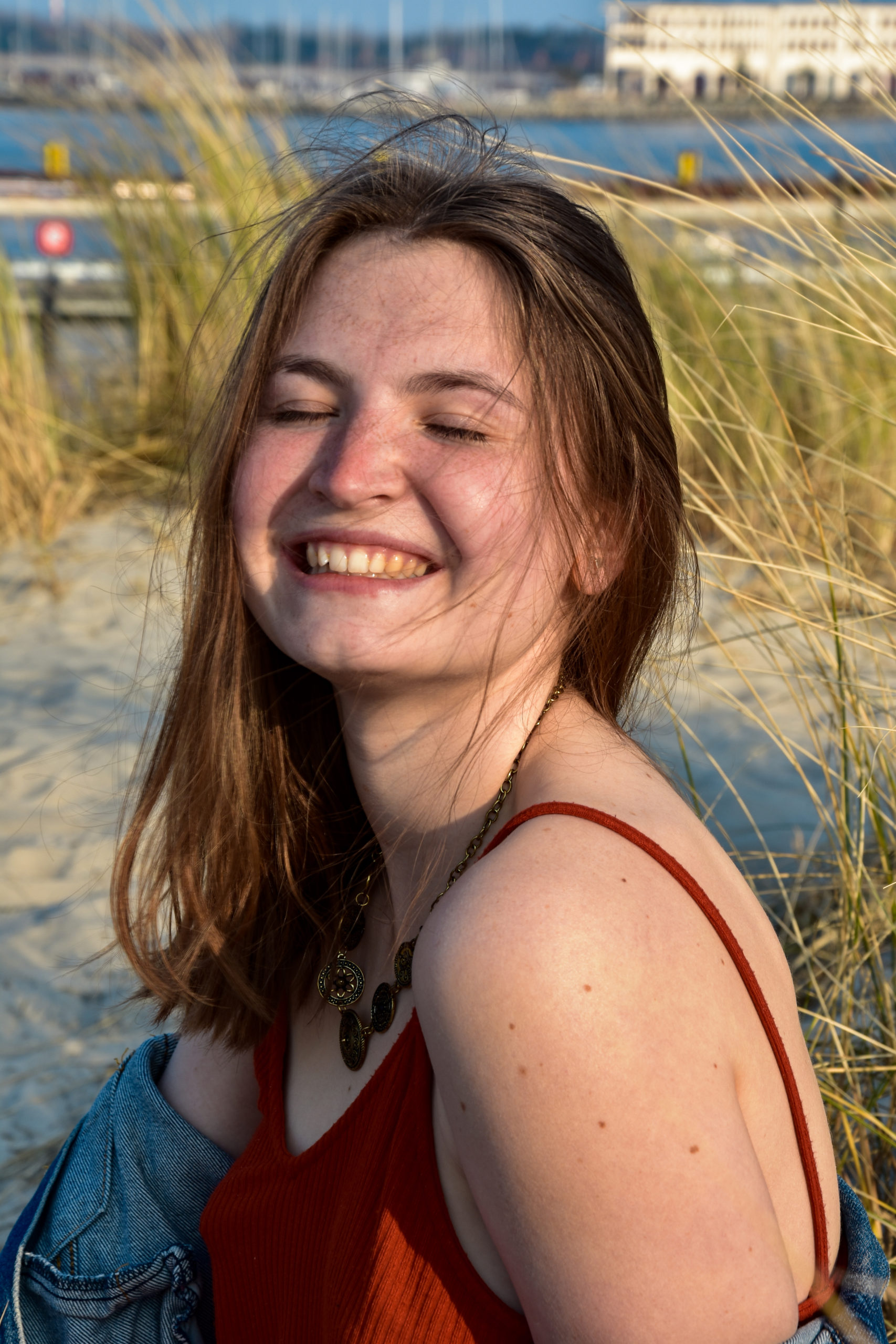 vegan, about me, Hannah sitting by the beach smiling